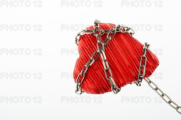 Red color heart shaped object in Chain on white background