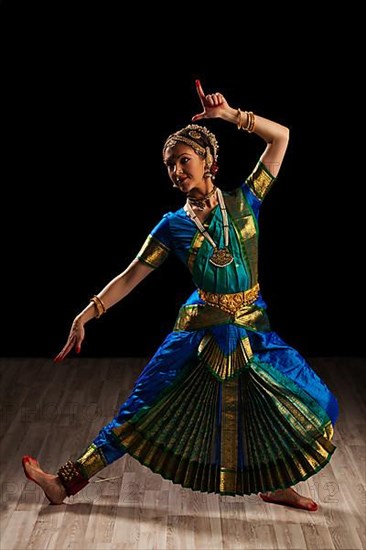 Young beautiful woman dancer exponent of Indian classical dance Bharatanatyam