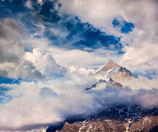 Snowcapped summit top of mountain in Himalayas in clouds. Himachal Pradesh