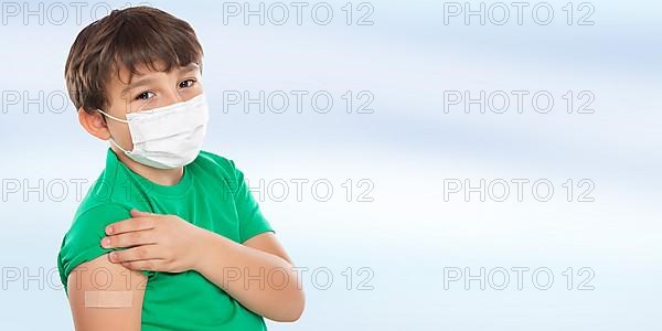 Child Boy with Plaster at Children Vaccination Mask against Coronavirus Corona Virus copy space Copyspace in Stuttgart