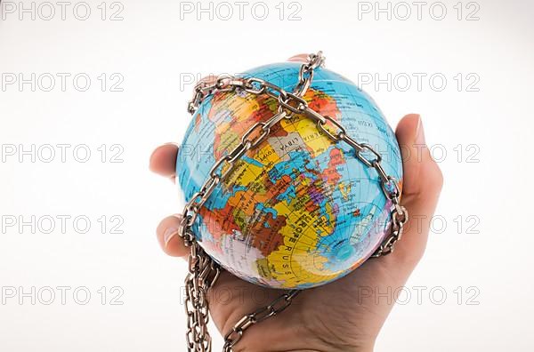 Globe in chain on a white background