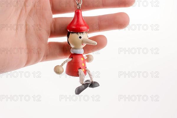 Pinocchio puppet in hand on a white background