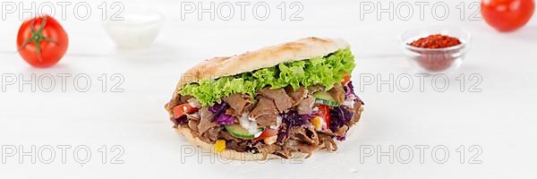 Doener Kebab Doner Kebap fast food in pita bread on wooden board Panorama in Stuttgart