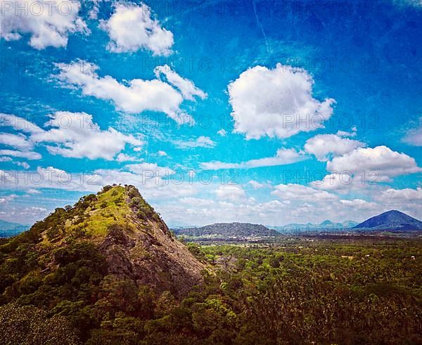 Vintage retro hipster style travel image of sky above small mountains