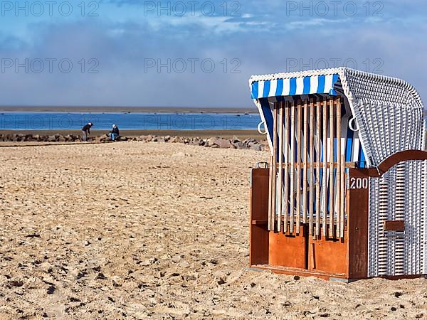 Locked beach chair on an empty sandy beach