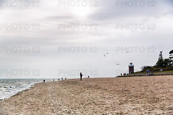 Strollers on the south beach in autumn