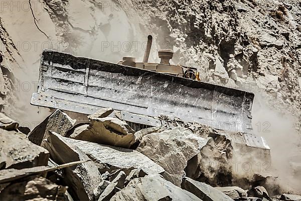 Bulldozer doing mountain road construction in Himalayas. Himachal Pradesh