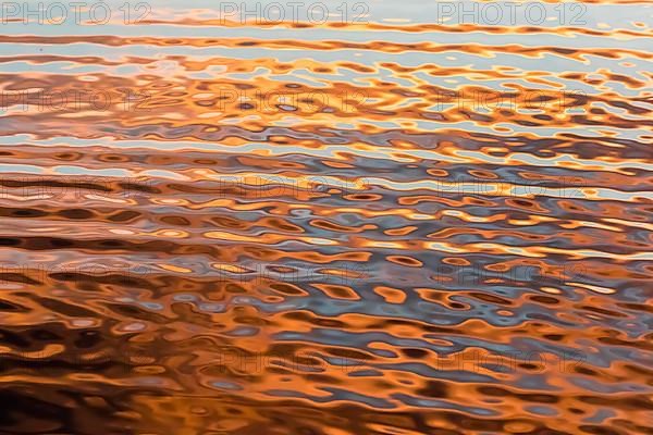 Creative photo. Wave effect on a lake at sunrise