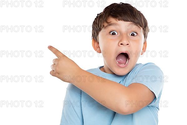 Child boy is amazed surprised points to advertising success isolated exempted in Stuttgart