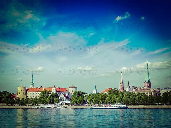 Vintage retro hipster style travel image of Riga over Daugava river: Riga Castle