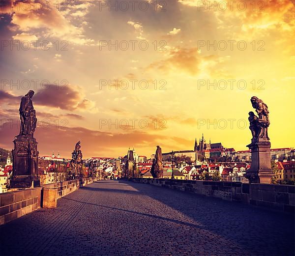 Vintage retro effect filtered hipster style travel image of Charles bridge and Prague castle in the early morning on surise. Prague