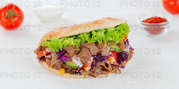 Doener Kebab Doner Kebap fast food in pita bread on wooden board Panorama in Stuttgart