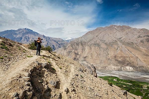 Photographer taking photos in Himalayas mountains. Spiti valley