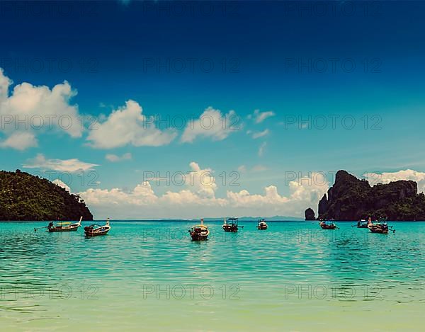 Vintage retro effect filtered hipster style travel image of long tail boats in bay. Phi Phi Island