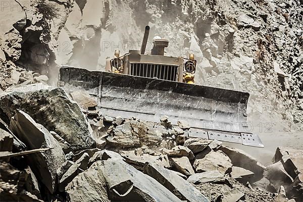 Bulldozer doing mountain road construction in Himalayas. Himachal Pradesh