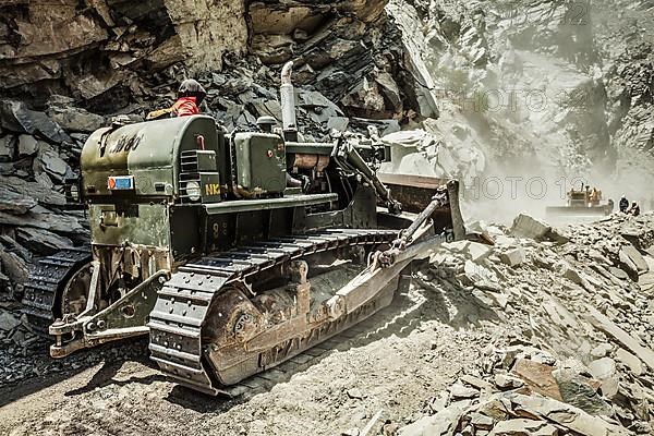 Bulldozer doing mountain road construction in Himalayas. Himachal Pradesh