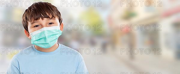 Child Boy with Mask against Corona Virus Corona Virus Portrait Portrait Face with Text Free Space Copyspace in the City in Stuttgart