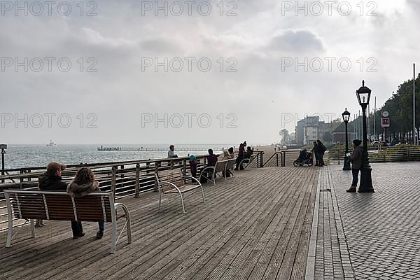 Pedestrians sitting on benches