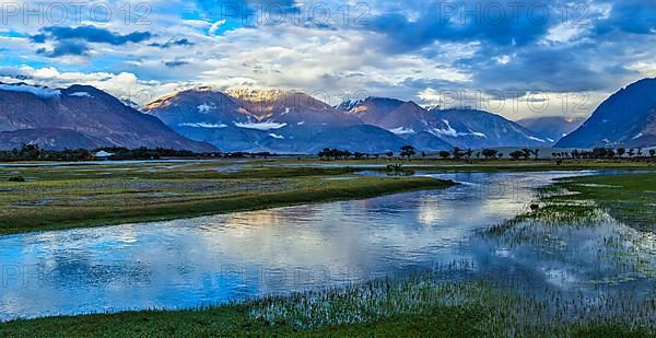 Panorama of Himalayas and landscape of Nubra valley on sunset. Hunber