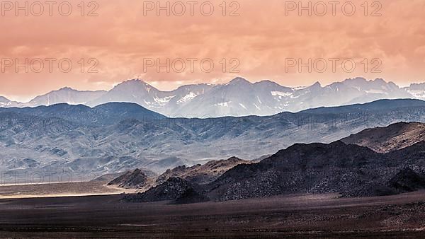 Backlit blue mountain ranges