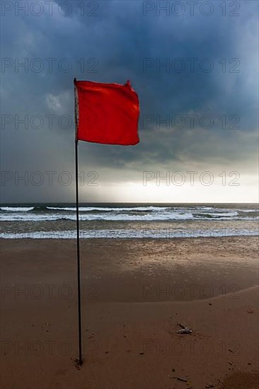 Severe storm warning flags on beach. Baga