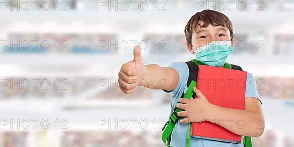 Young Pupil Child Boy With Mask Against Corona Virus Corona Virus In School Showing Thumbs Up With Text Free Space Copyspace in Stuttgart