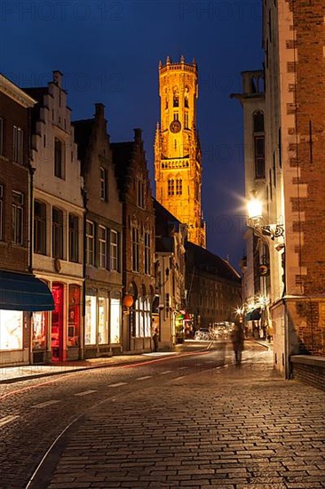 Bruges street in night. Belfry in background. Bruges