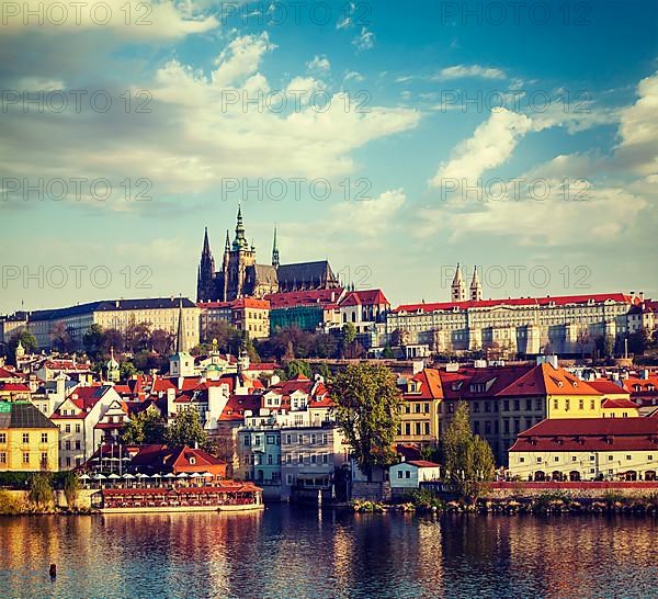 Vintage retro hipster style travel image of Mala Strana and Prague castle over Vltava river. Prague