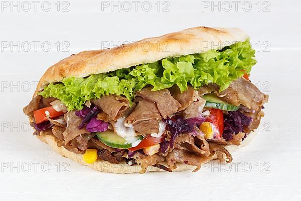 Doener Kebab Doner Kebap half fast food meal in pita bread panorama on wooden board in Stuttgart