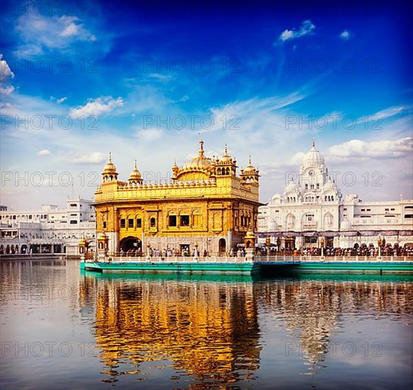 Vintage retro hipster style travel image of famous India attraction Sikh gurdwara Golden Temple