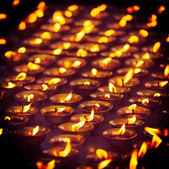 Vintage retro effect filtered hipster style travel image of burning candles in Buddhist temple. Tsuglagkhang complex