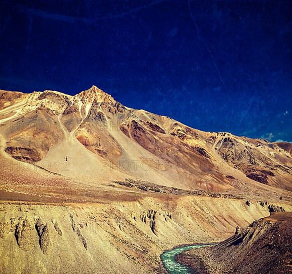 Vintage retro effect filtered hipster style travel image of Himalayan landscape in Hiamalayas near Baralacha La pass with grunge texture overlaid. Himachal Pradesh