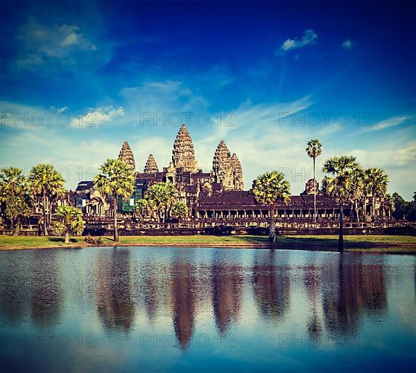 Vintage retro effect filtered hipster style travel image of Cambodia landmark Angkor Wat with reflection in water