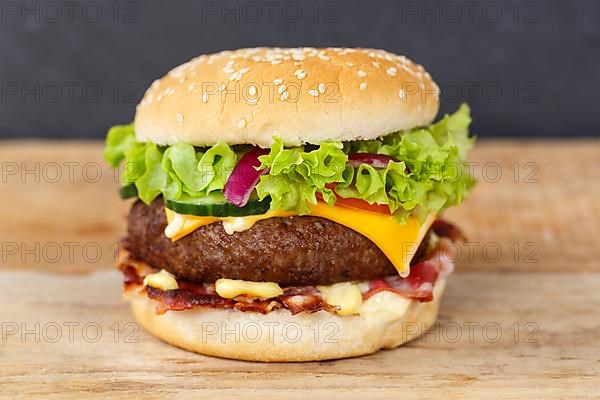 Hamburger cheeseburger fast food meal on wooden board in Stuttgart