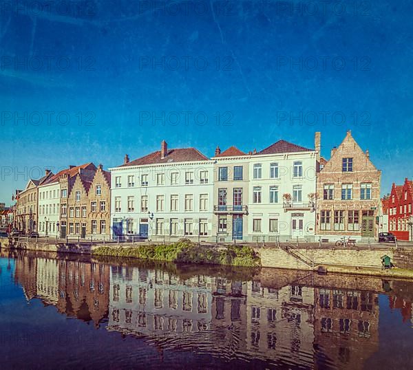 Vintage retro hipster style travel image of canal and medieval houses. Bruges