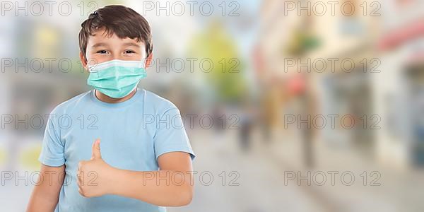 Child Boy With Mask Against Corona Virus Corona Virus Showing Thumbs Up In City With Text Free Space Copyspace in Stuttgart