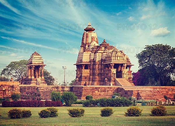 Vintage retro hipster style travel image of Khajuraho Devi Jagdamba temple and mahadev mandapa on sunrise. Khajuraho