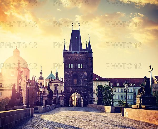 Vintage retro hipster style travel image of Charles bridge tower in Prague on sunrise