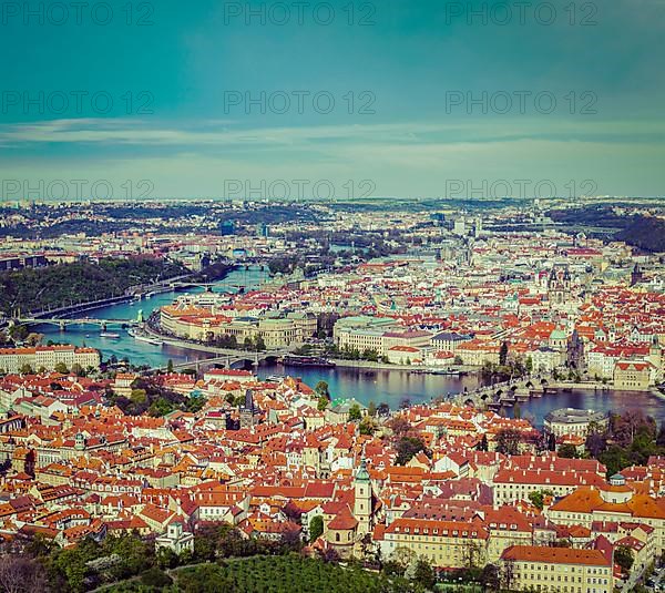 Vintage retro hipster style travel image of aerial view of Charles Bridge over Vltava river and Old city from Petrin hill Observation Tower. Prague