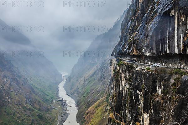 Car on road in Himalayas mountains above precipice
