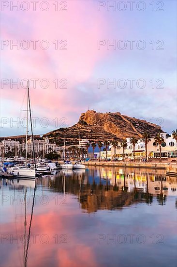 Port of Alicante in the evening Port dAlacant Marina with boats and view of Castillo Castle Holiday travel city in Alicante