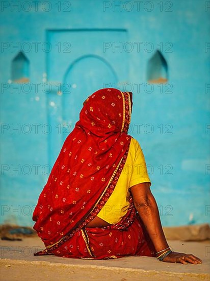 Unidentified Indian rural woman in traditional sari shot from behind