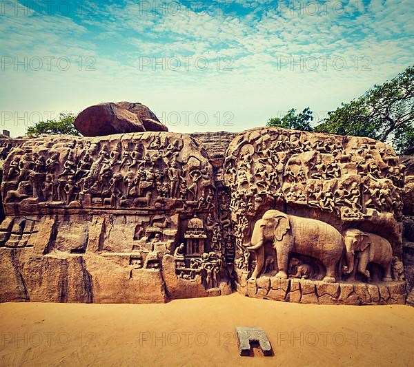 Vintage retro hipster style travel image of Descent of the Ganges and Arjuna's Penance ancient stone sculpture