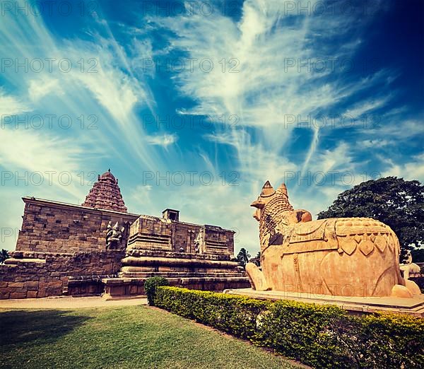 Vintage retro hipster style travel image of Hindu temple Gangai Konda Cholapuram with giant statue of bull Nandi. Tamil Nadu