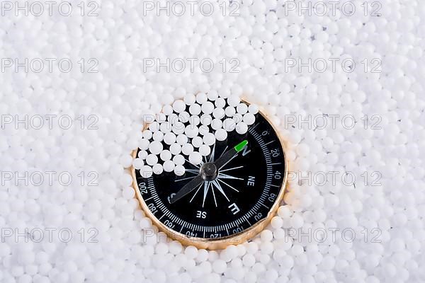 Compass on little white polystyrene foam balls