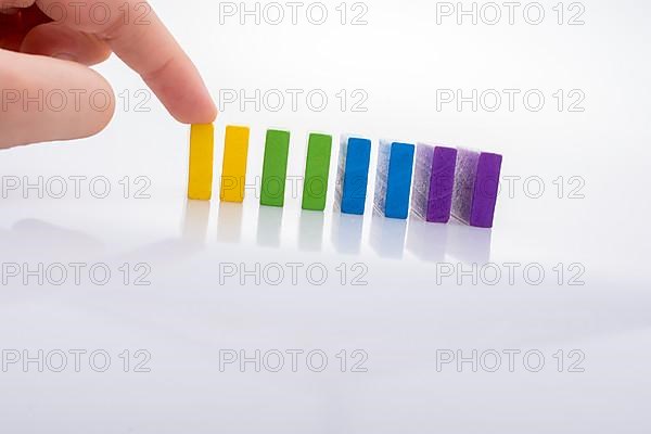 Colorful Domino Blocks in a line on a white background