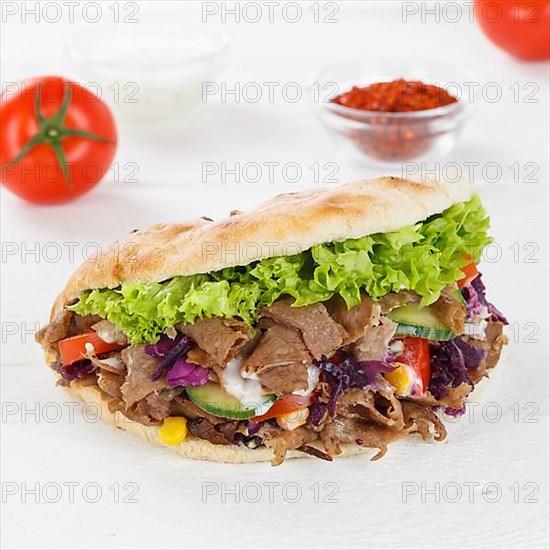 Doener Kebab Doner Kebap fast food meal in pita bread on wooden board square in Stuttgart