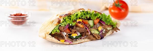 Doener Kebab Doner Kebap fast food in pita bread on wooden board Panorama in Stuttgart