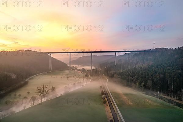 Motorway bridge with forest and fog in the sunrise