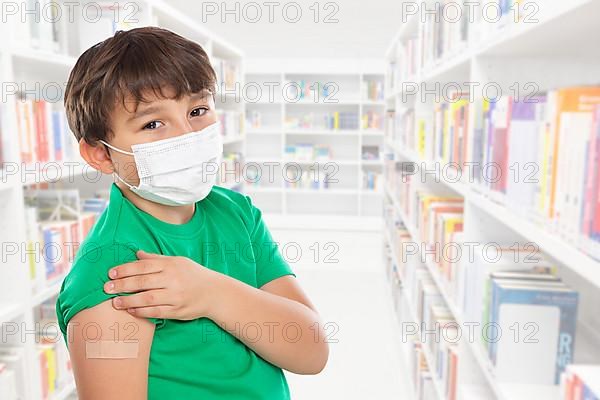 Child boy with plaster at children vaccination in school mask against coronavirus corona virus text free space copyspace in Stuttgart